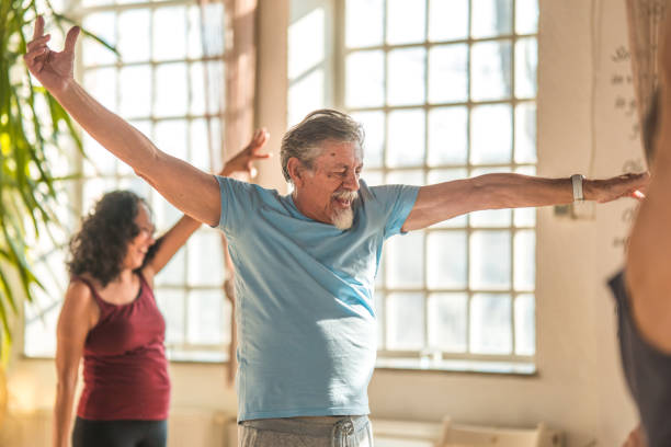 healthy aging: a multicultural yoga group engaging in fitness and fun - 16019 imagens e fotografias de stock