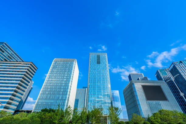 istock modern office building with green trees 1615292450
