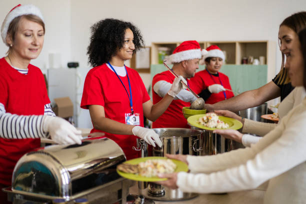 istock Benevolent helpers serving food in a homeless shelter 1615375012