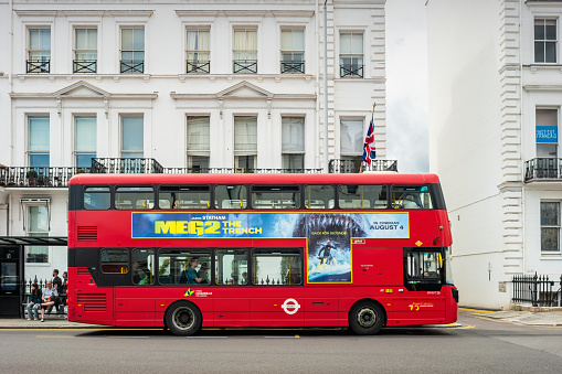 A Double-Decker bus stands in South Kensington, London, England, UK on a cloudy day.