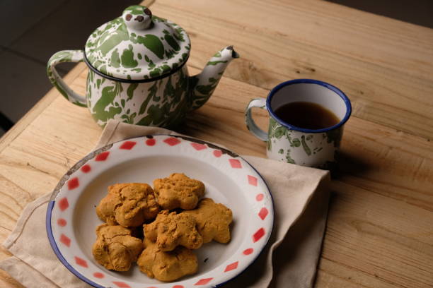 istock Kue Jahe Jadul, Star-shaped gingerbread cookies on a cooling rack. Pekalongan's typical ginger cake. Indonesian food. Cookies Jahe. A cup of tea. 1615445382
