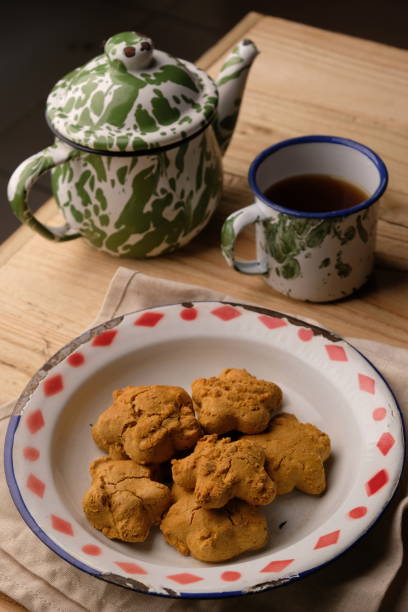 istock Kue Jahe Jadul, Star-shaped gingerbread cookies on a cooling rack. Pekalongan's typical ginger cake. Indonesian food. Cookies Jahe. A cup of tea. 1615445915