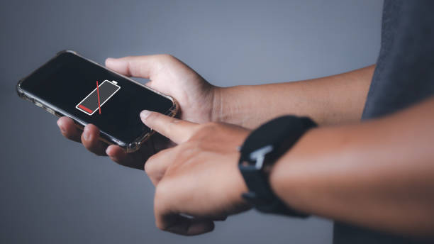 istock Smartphone with low battery, Businessman holding a smartphone low battery. 1615497922