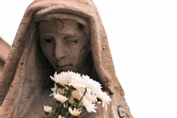 sad thinking woman statue with close view to her face in a cemetery park