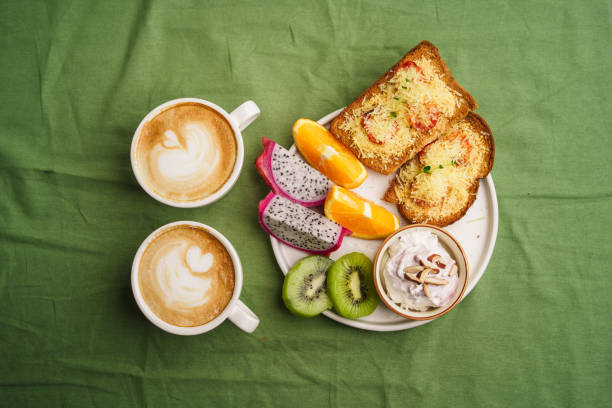 istock Breakfast toast with cheese and tomatoes, fruit, yogurt. 1615533982