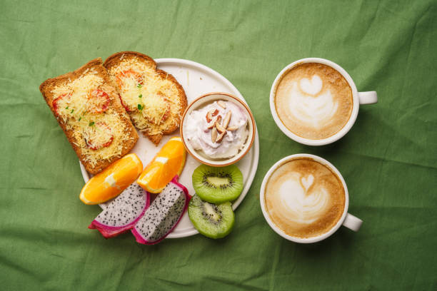 istock Breakfast toast with cheese and tomatoes, fruit, yogurt. 1615533986