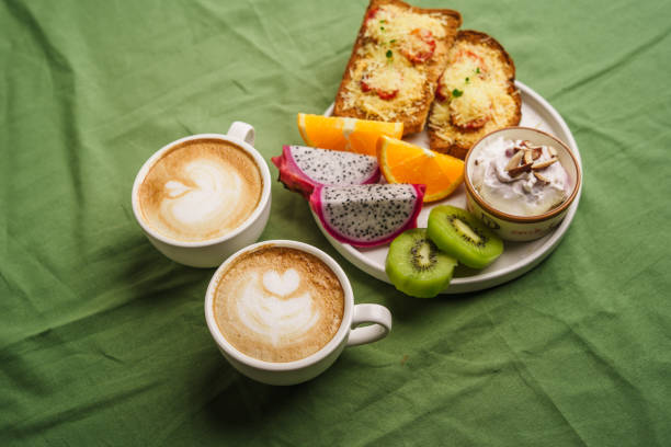 istock Breakfast toast with cheese and tomatoes, fruit, yogurt. 1615533987