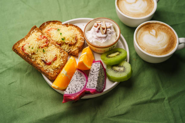 istock Breakfast toast with cheese and tomatoes, fruit, yogurt. 1615534354