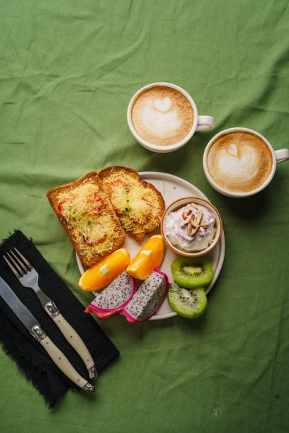 istock Breakfast toast with cheese and tomatoes, fruit, yogurt. 1615534514