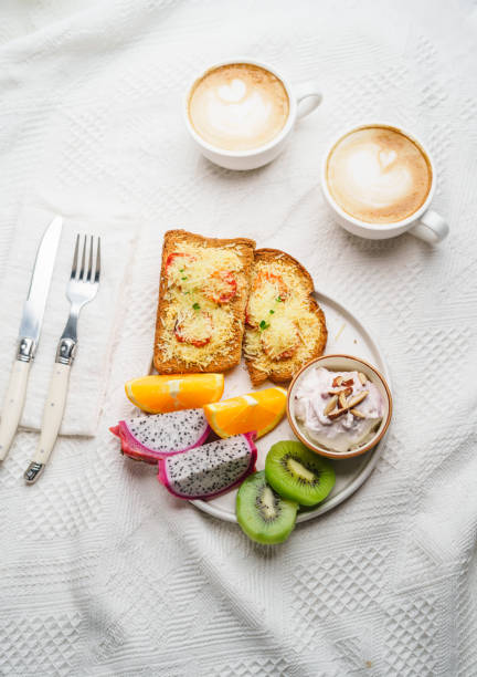istock Breakfast toast with cheese and tomatoes, fruit, yogurt, coffee. 1615534515