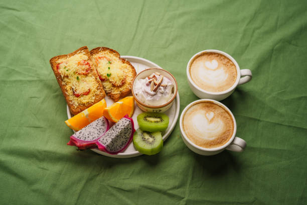 istock Breakfast toast with cheese and tomatoes, fruit, yogurt. 1615534520
