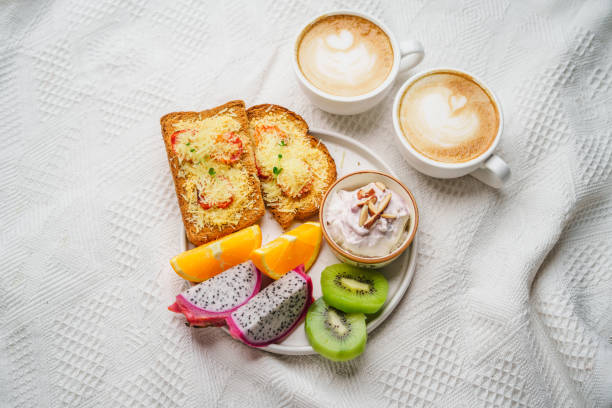 istock Breakfast toast with cheese and tomatoes, fruit, yogurt, coffee. 1615534542
