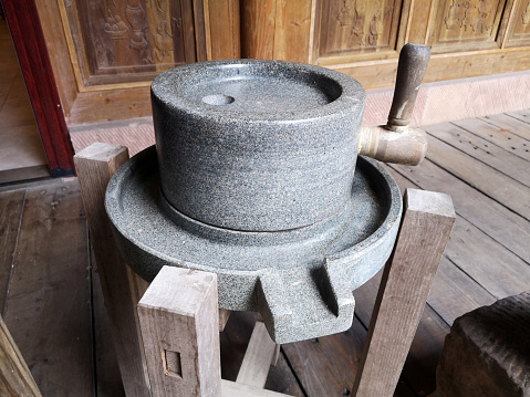 Manual old millstone, hand grain mill. Traditional Grinding with stone
