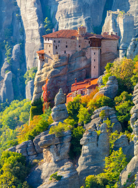istock Unique Meteora monasteries. Zoom view on the Holy Roussanou Monastery placed on the edge  of high rock. The Meteora area is on UNESCO World Heritage. Greece 1615567404