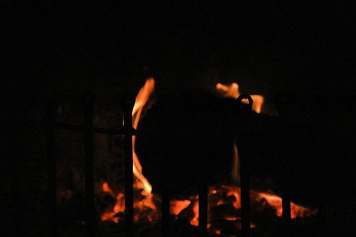 Flame is burning in dark fireplace