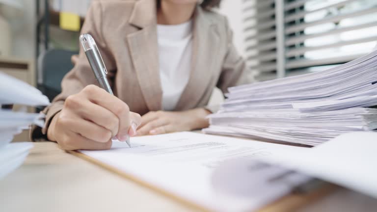 Closeup of female lawye or judge hands taking notes in courtroom,Lawyer business working on table office.