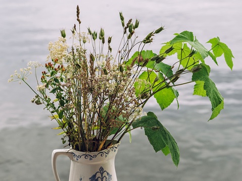 A closeup of a bouquet of wildflowers on the beach