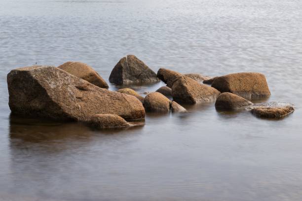 istock Scenic view of rocks on the beach against the sea 1615615708