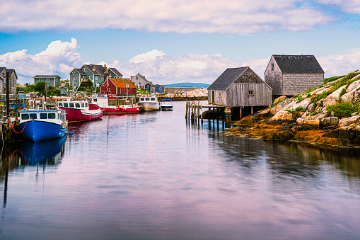 Peggy's Cove Seascape with moored boats and weathered seaside shacks in Nova Scotia, Canada