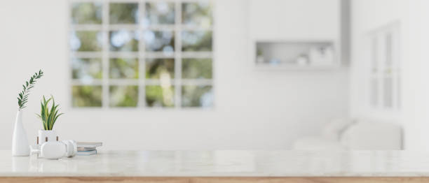 istock Copy space on a white tabletop in a modern white living room room. 1615624295