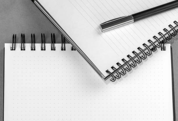 Home and office desk table with paper notebook, pen. Flat lay style, minimal layout. Top view
