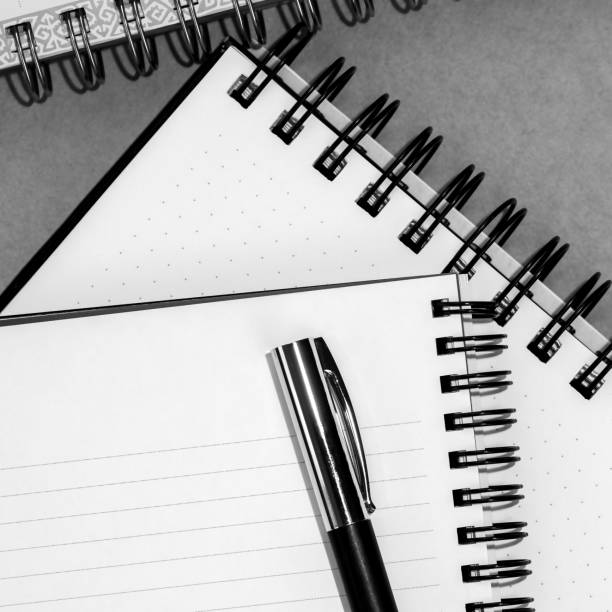 istock Mockup blank open notepad. Spiral copybook or organizer and black pen, place for text. 1615640080
