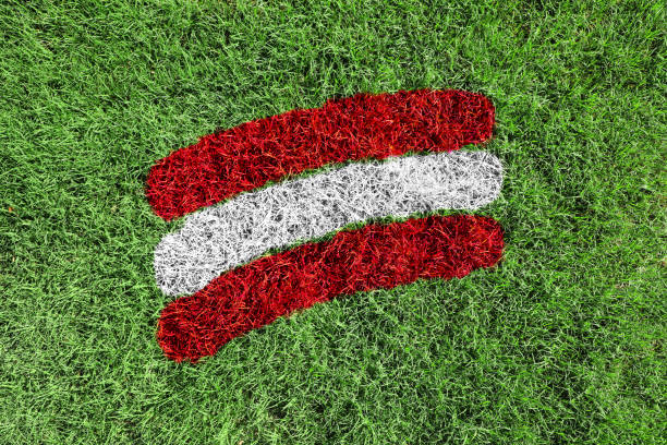 istock Austrian flag colors painted on grass field 1615648402