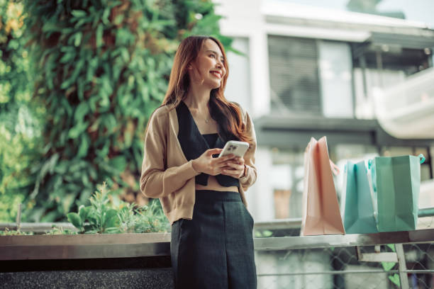 istock Stylish lady strolls downtown, explores new stores, and smiles while enjoying chic weekend shopping 1615667449