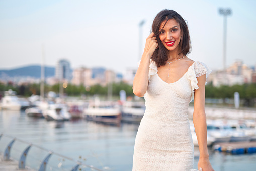positive emotion model at seaside in white dress