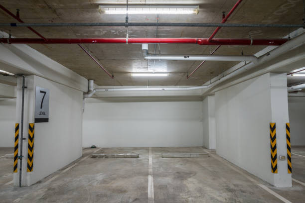 istock Parking garage interior in residential building at night with lighting. 1615688010