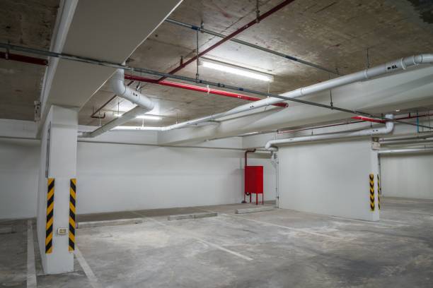 istock Parking garage interior in residential building at night with lighting. 1615688016
