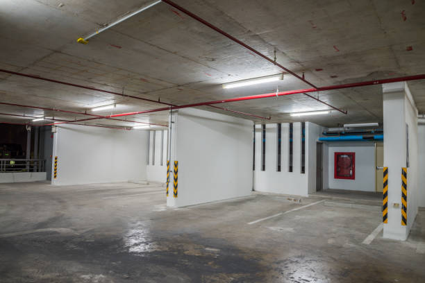 istock Parking garage interior in residential building at night with lighting. 1615688038