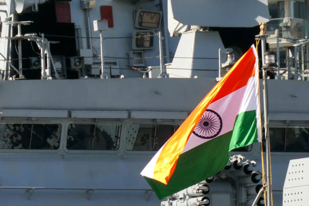 INS Kolkata Bridge Flag The Indian flag on the bow flagpole of INS Sahyadri (F49), while in the background is the bridge and one of the RBU-6000 (RPK-8) anti-submarine rocket launchers of INS Kolkata (D63).  They are warships of the Indian Navy docked next to each other at Garden Island naval base in Sydney Harbour.  This image was taken on a sunny afternoon on 12 August 2023. Indian Navy stock pictures, royalty-free photos & images