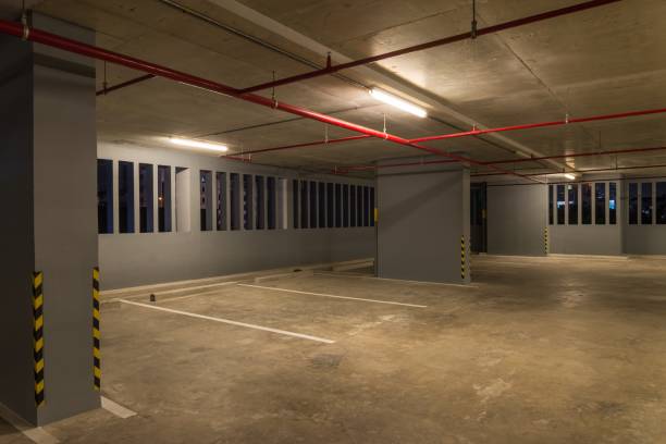 istock Parking garage interior in building at night with warm lighting. 1615735812