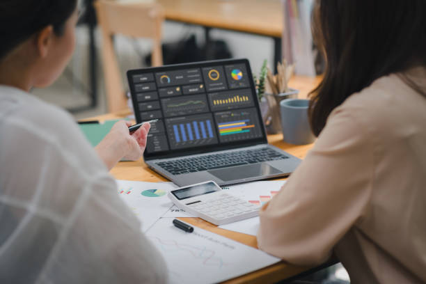istock Two businesspeople or an accountant team are analyzing data charts, graphs, and a dashboard on a laptop screen in order to prepare a statistical report and discuss financial data in an office. 1615763246