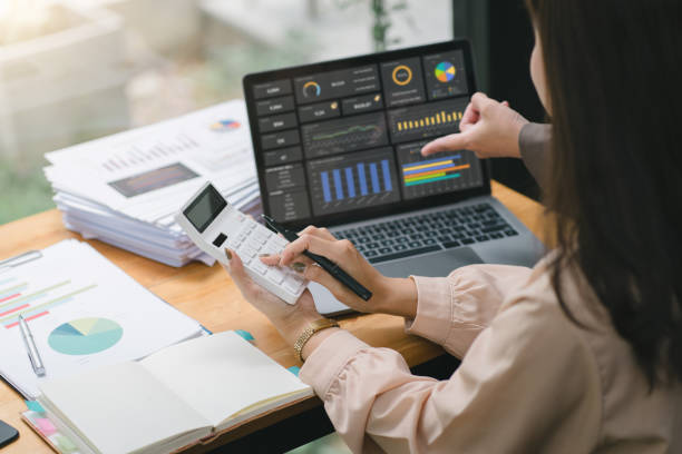 istock Two businesspeople or an accountant team are analyzing data charts, graphs, and a dashboard on a laptop screen in order to prepare a statistical report and discuss financial data in an office. 1615763756