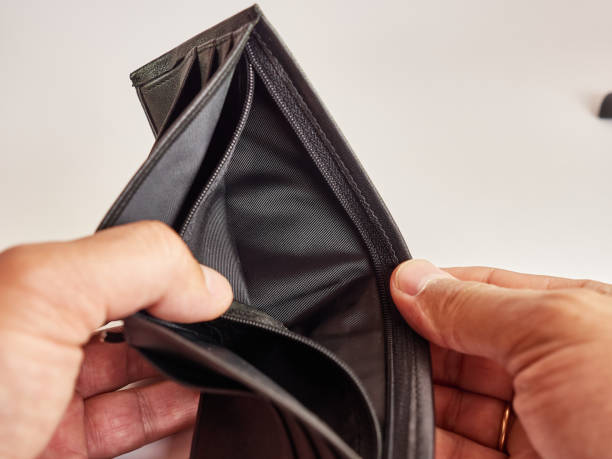istock A man looks into an empty wallet on a white background. 1615773666