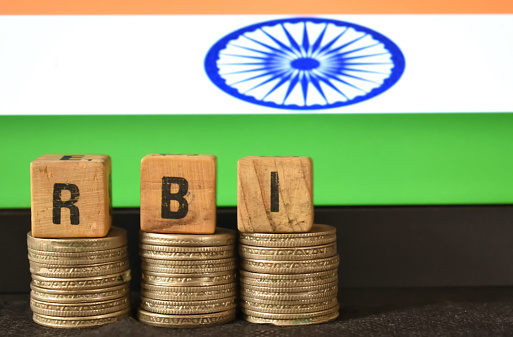 A closeup selective focus picture of a letters of RBI against the background of Indian Flag