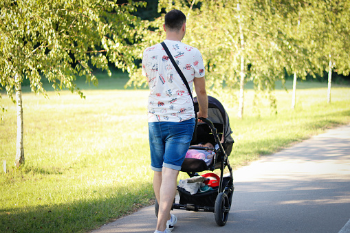 Proud father and baby walking in the park in nature