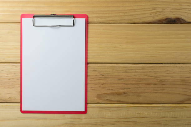 istock Blank red clipboard on wooden background. 1615832939