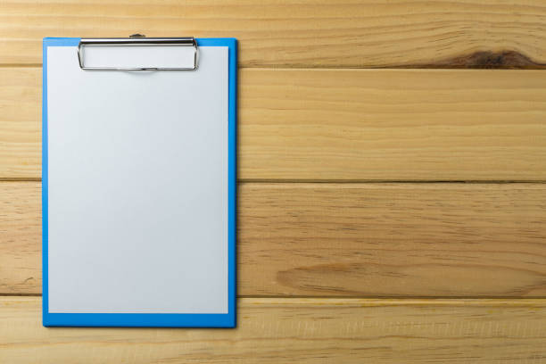 istock Blank blue clipboard on wooden background. 1615833369