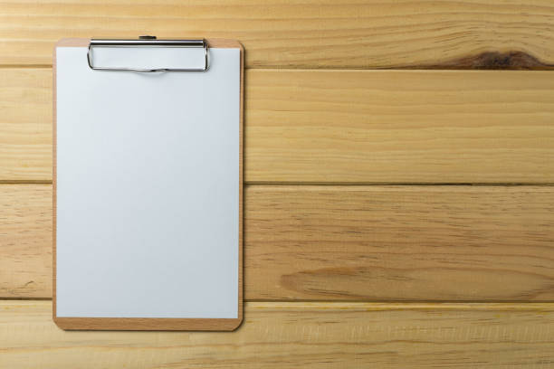 istock Blank clipboard on wooden background. 1615833374