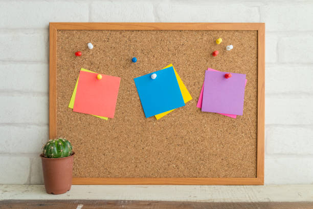 istock Cork board, colorful blank paper notes and cactus pot with white wall background. 1615846047