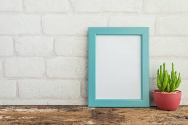istock Blue photo frame on old wooden table with succulent pot. 1615862014
