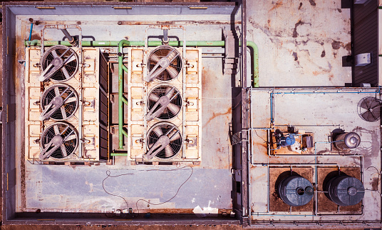 Old external air conditioning units on a roof top. Aerial view of air conditioning unit machine outside. VRF system. chiller system. Direct from above shot.