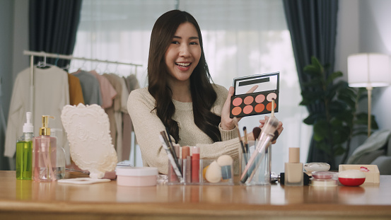 Shot of a Young beautiful Asian woman beauty vlogger or blogger recording a makeup tutorial to share on social media.