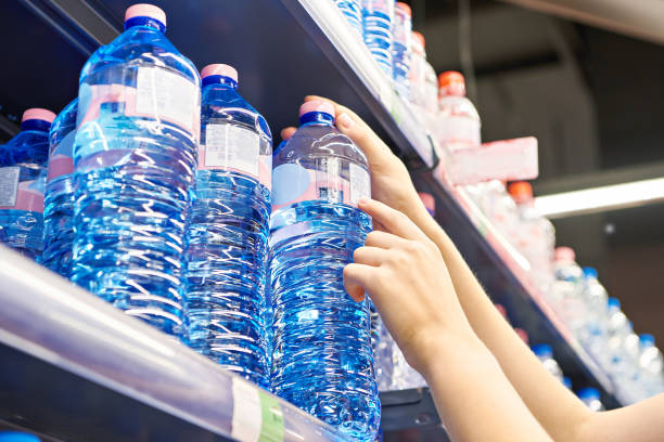 istock Drinking water in hand at shop 1615888429