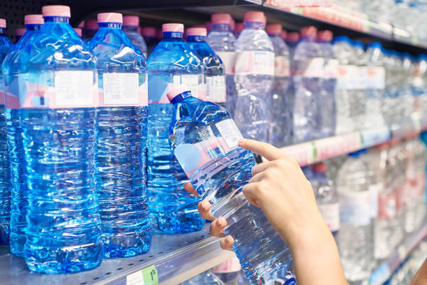 istock Drinking water in hand at shop 1615889000
