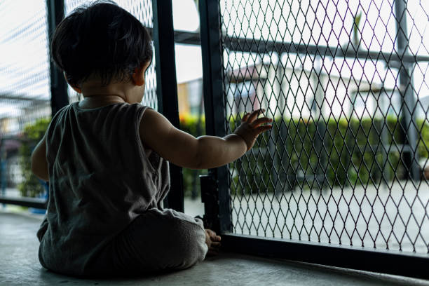 istock Baby Boy Trying Open Door 1615890779
