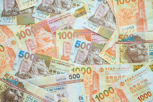 Close-up Hong Kong dollar bills currency banknotes 500 and 1000 HK dollars. Hong Kong currency, economy and investment concept.